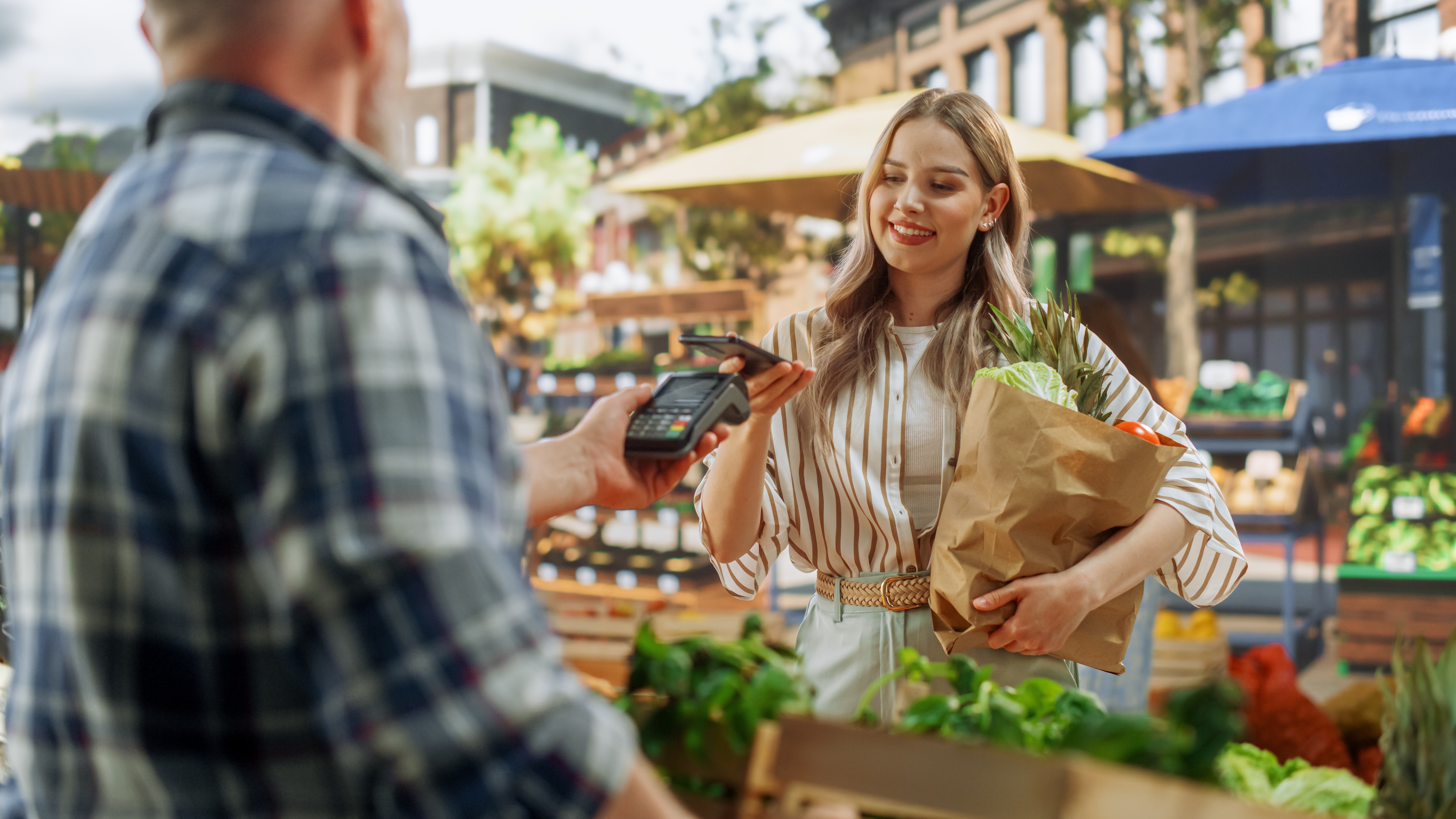 woman paying for her groceries with her phone